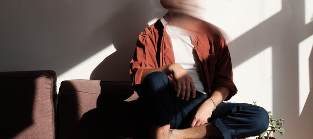 blurry photo of BENDY sitting on a couch with a the golden light of the sun